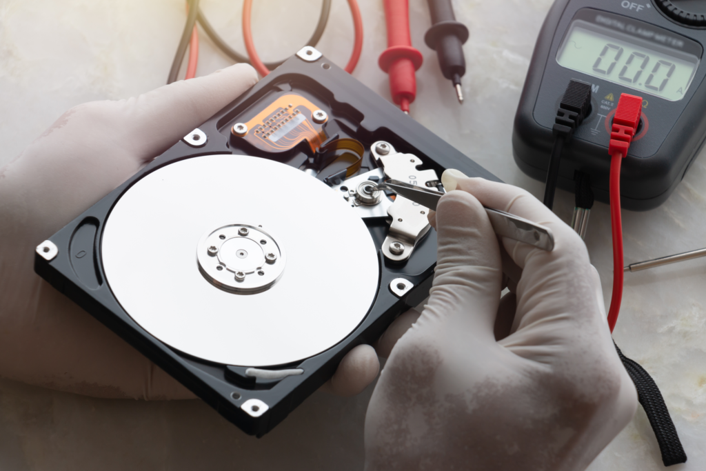  A technician performing a device evaluation on a damaged hard drive 