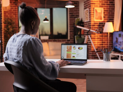 A business owner sitting while working on her laptop