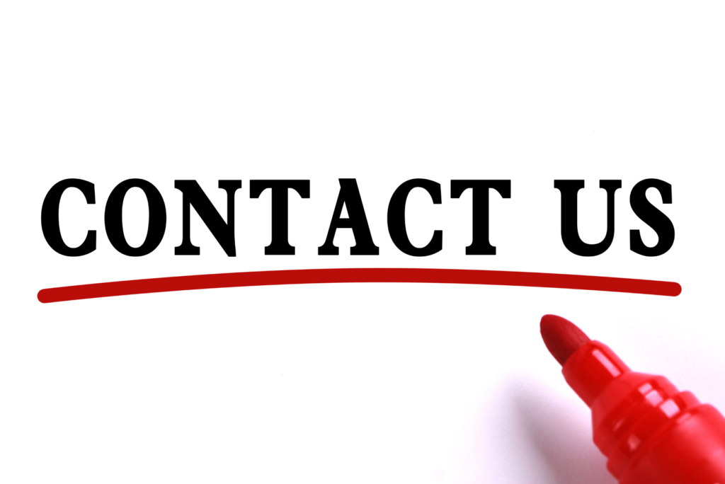 Contact us written in a white paper with a marker