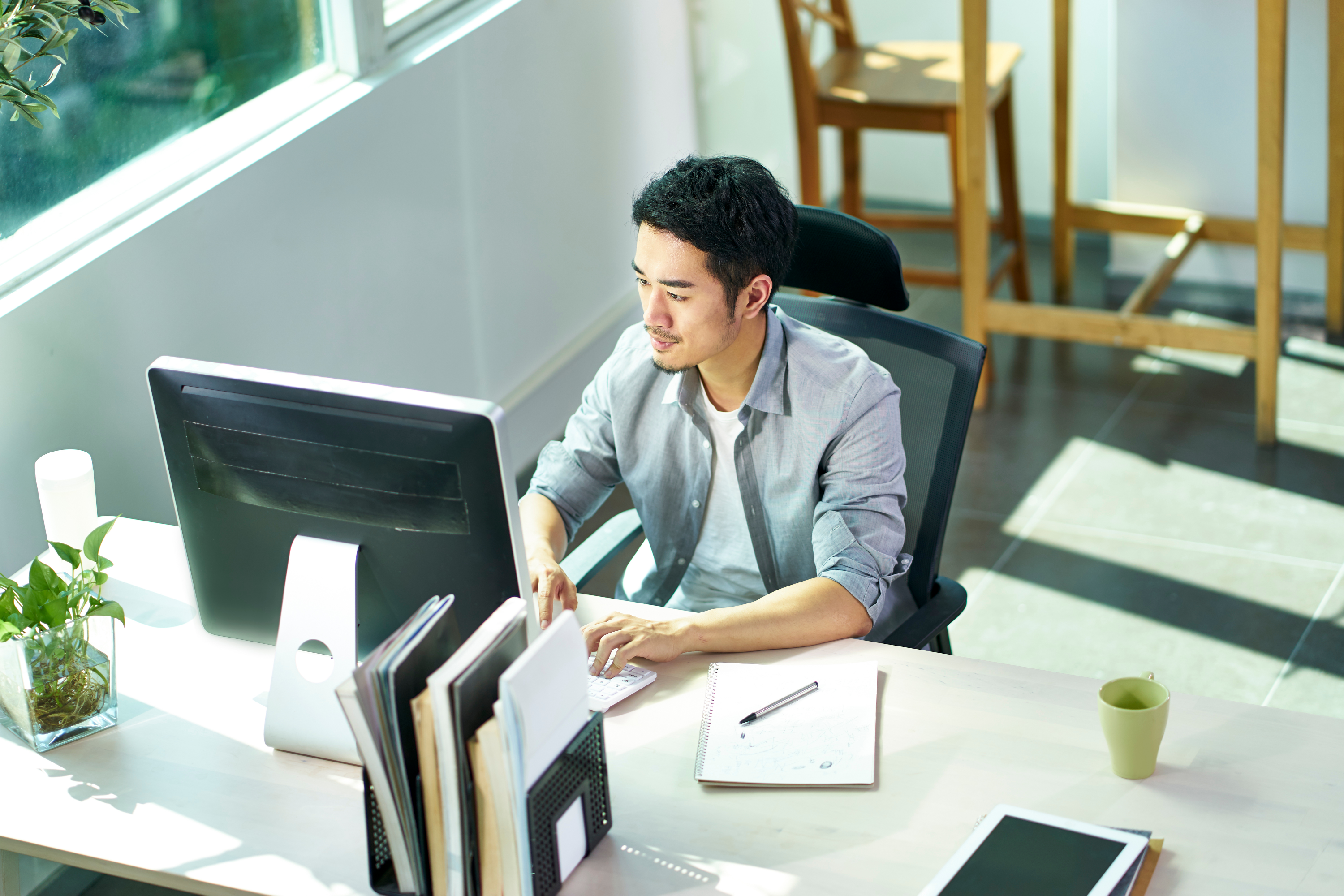 A business owner working on an office computer