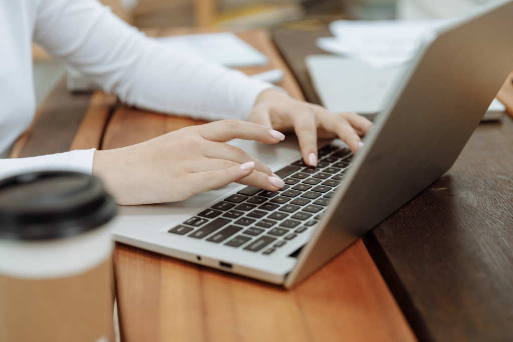 A business woman typing on a laptop for work