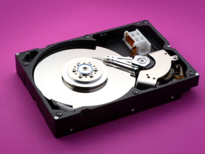 open hard drive showing its parts in a purple background